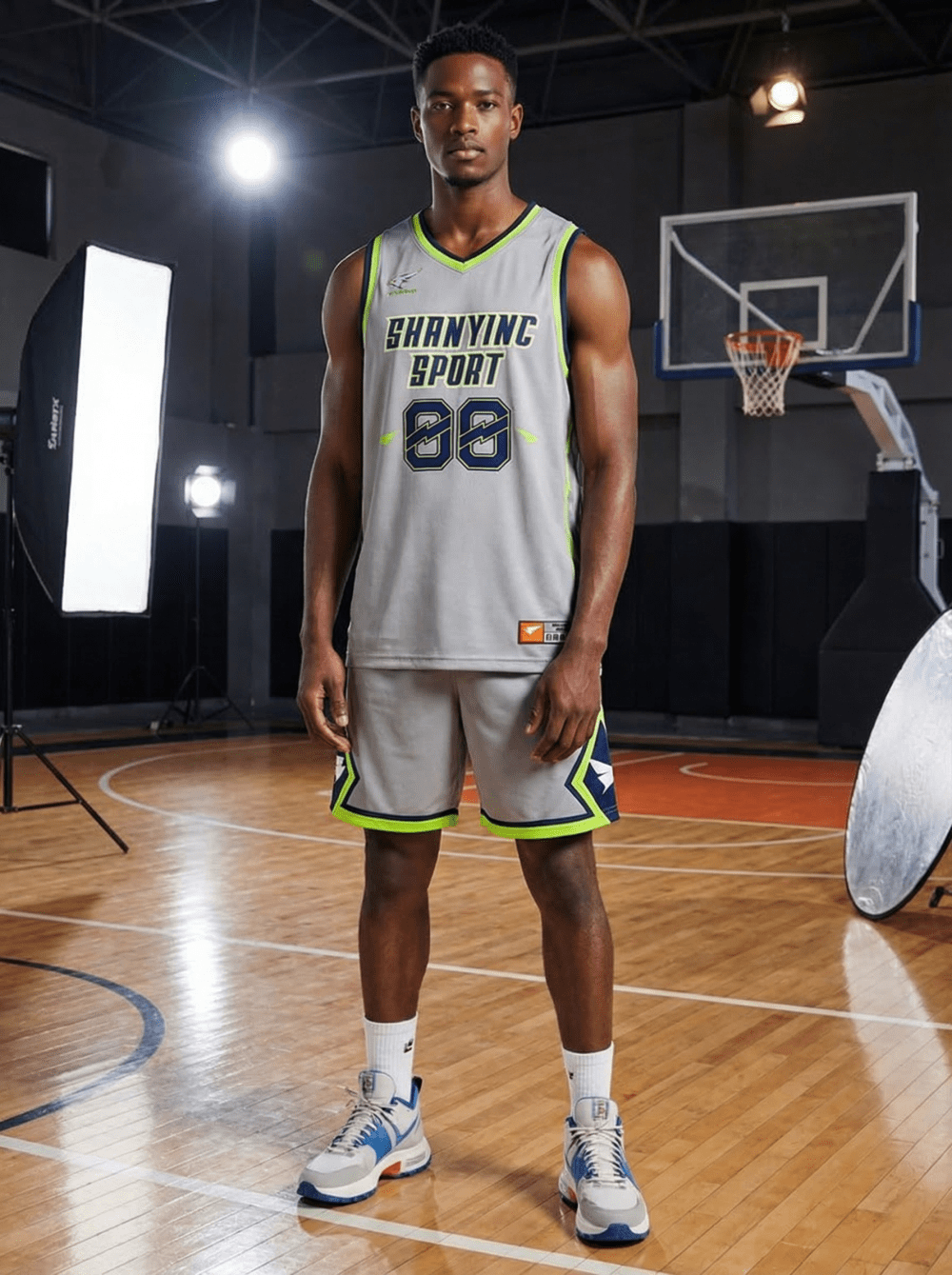 Athletic man modeling grey neon green reversible basketball uniform with private logo and number