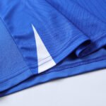 AAA+ Grade Blue soccer jersey mockup with overlapping v-neck and raglan sleeves for wholesale custom soccer jerseys.