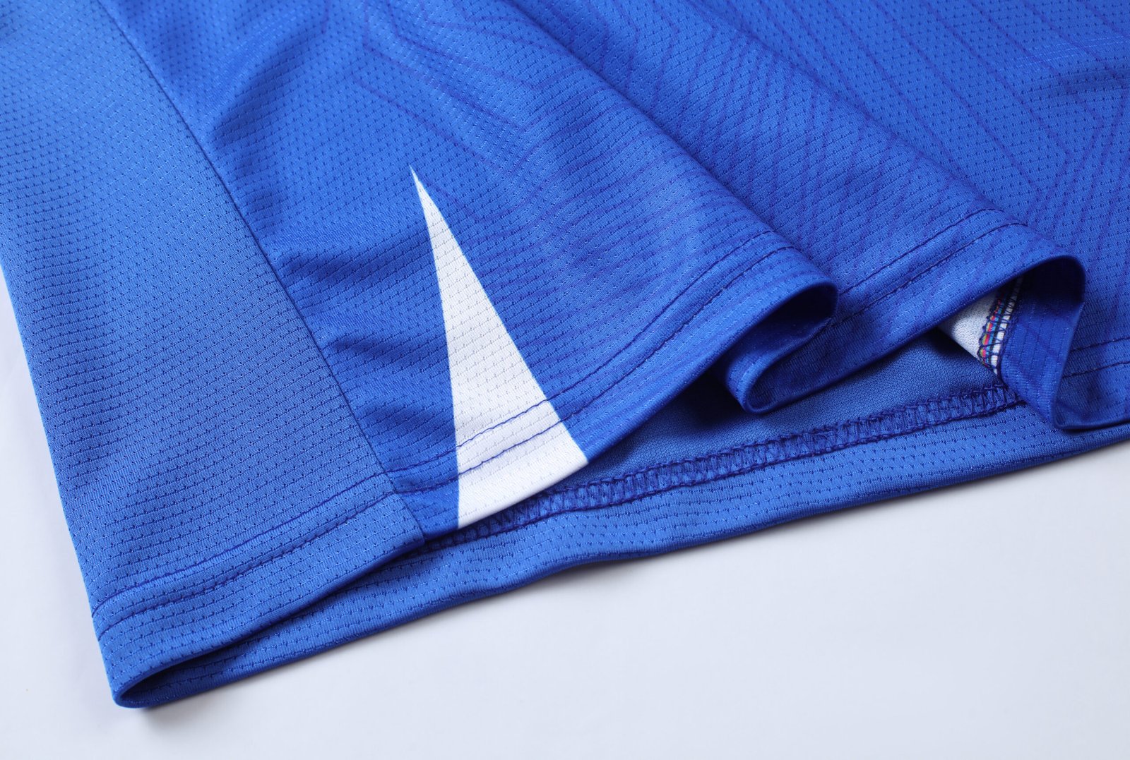 AAA+ Grade Blue soccer jersey mockup with overlapping v-neck and raglan sleeves for wholesale custom soccer jerseys.