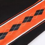 Black and orange argyle pattern detail on reversible basketball jersey side panel