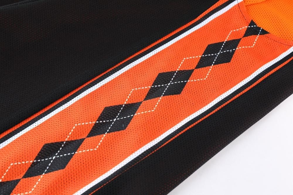 Black and orange argyle pattern detail on reversible basketball jersey side panel