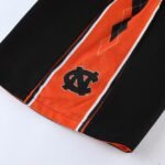 lack and orange reversible basketball shorts featuring NC logo close-up view