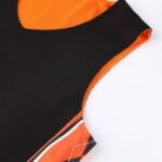Black reversible basketball jersey with bright orange inner neck and mesh detail