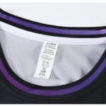 Black basketball jersey collar with purple trim and clothing size tag