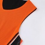Breathable orange and black reversible basketball jersey collar and neck detail