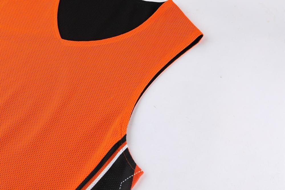 Breathable orange and black reversible basketball jersey collar and neck detail
