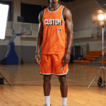 Man wearing orange lightning pattern custom basketball uniform with number 7