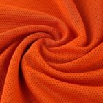 Breathable orange mesh fabric texture of basketball jersey material