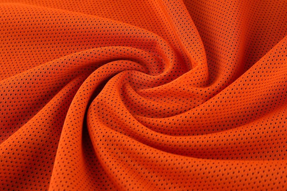 Breathable orange mesh fabric texture of basketball jersey material