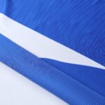 AAA+ Grade Blue soccer jersey mockup with overlapping v-neck and raglan sleeves for wholesale custom soccer jerseys.