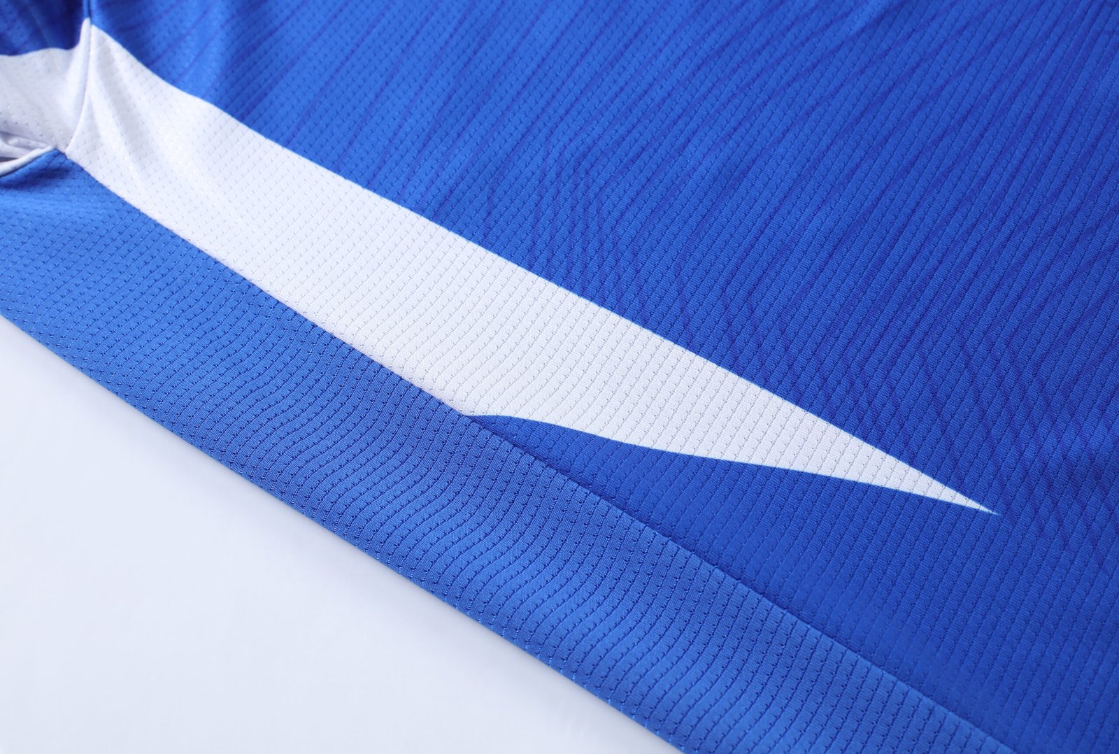 AAA+ Grade Blue soccer jersey mockup with overlapping v-neck and raglan sleeves for wholesale custom soccer jerseys.