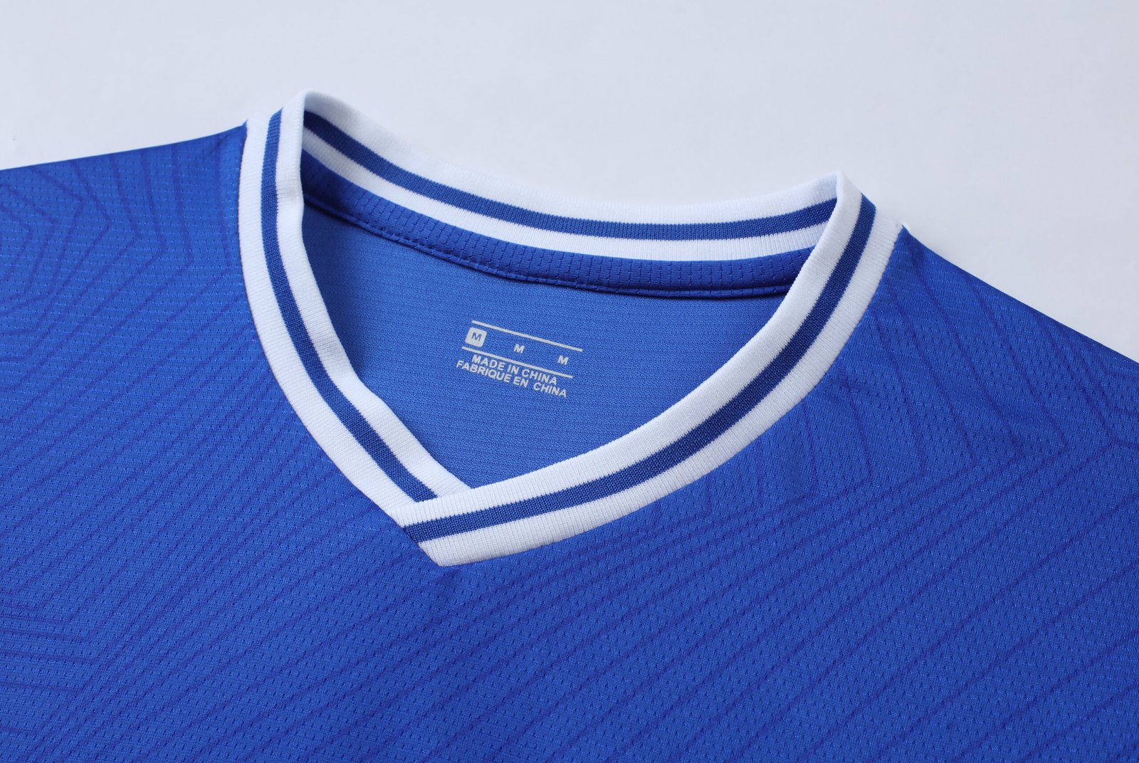 Pro-grade 150GSM Pinhole Mesh Red soccer jersey mockup with overlapping v-neck and raglan sleeves for wholesale custom soccer jerseys.