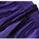 Purple basketball shorts with black drawstring and elastic waistband closeup