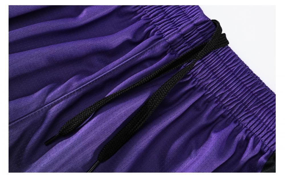 Purple basketball shorts with black drawstring and elastic waistband closeup
