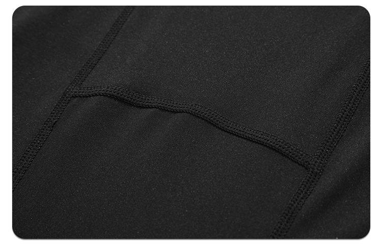 Close-up of black compression fabric with flatlock stitching and panel design