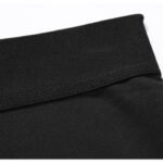 Close-up of black compression pants bottom hem with reinforced stitching