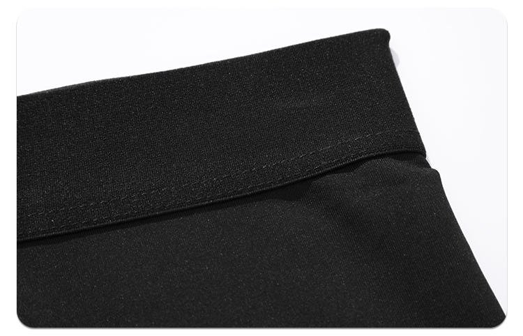 Close-up of black compression pants bottom hem with reinforced stitching