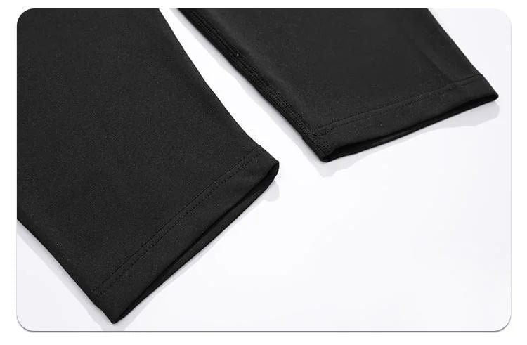 Close-up of black compression pants bottom hem with reinforced stitching