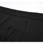 Detailed view of wide elastic waistband on black compression pants