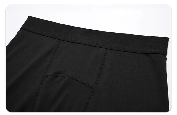 Detailed view of wide elastic waistband on black compression pants