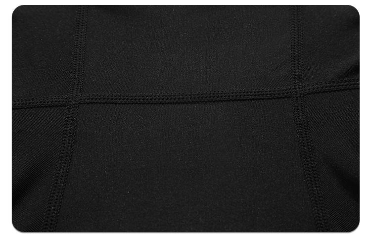 Black compression pants side pocket and seam construction detail
