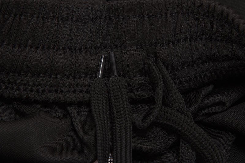 Black drawstring and waistband detail of jogger pants