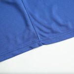 Close-up of blue soccer shorts hem with reinforced stitching