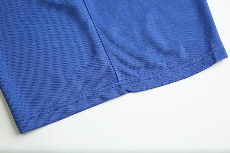 Close-up of blue soccer shorts hem with reinforced stitching