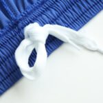 White drawstring detail on blue soccer shorts waistband