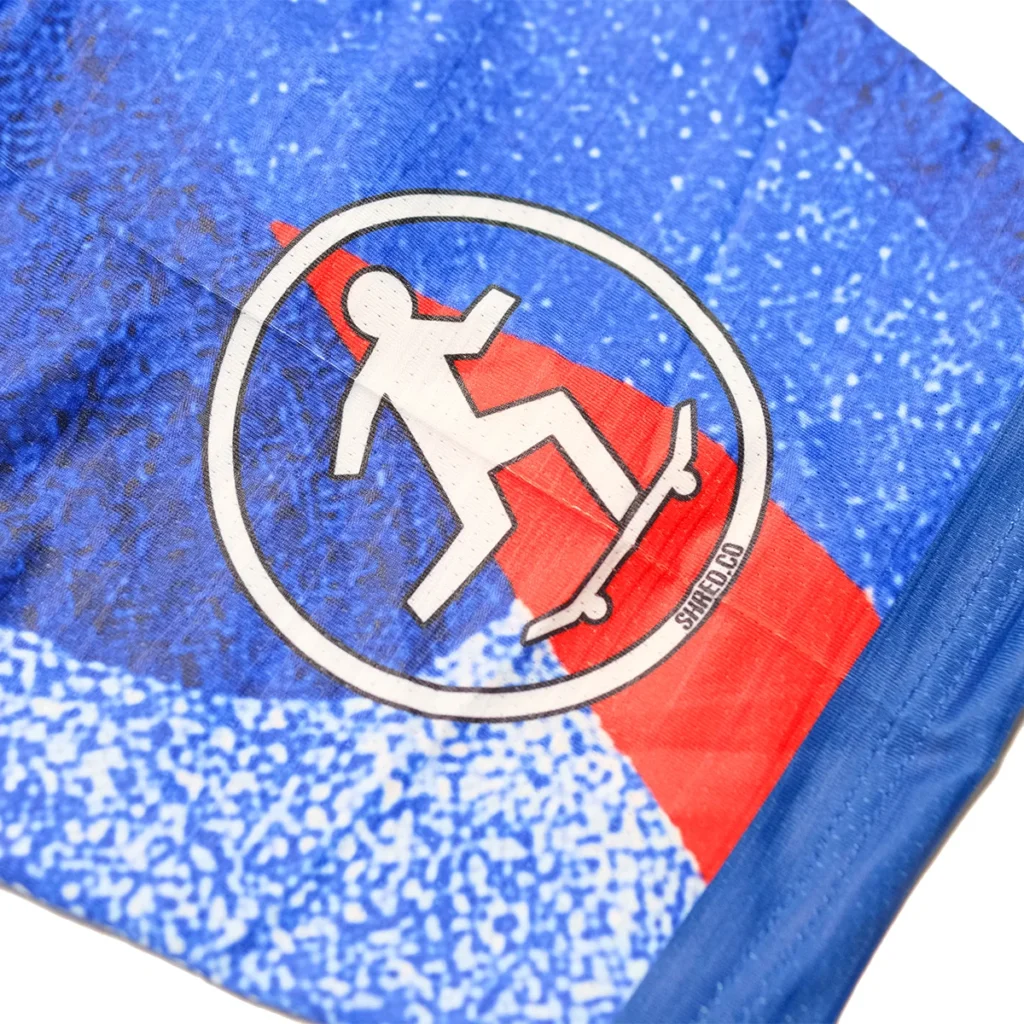 Skateboard logo patch detail on blue full sublimation soccer jersey