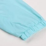 Elastic cuff detail of light blue soccer windbreaker sleeve