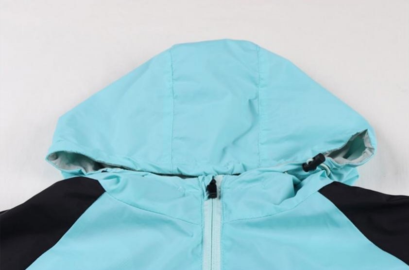 Hood and collar close-up of light blue soccer windbreaker