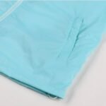 Side pocket detail of light blue soccer windbreaker