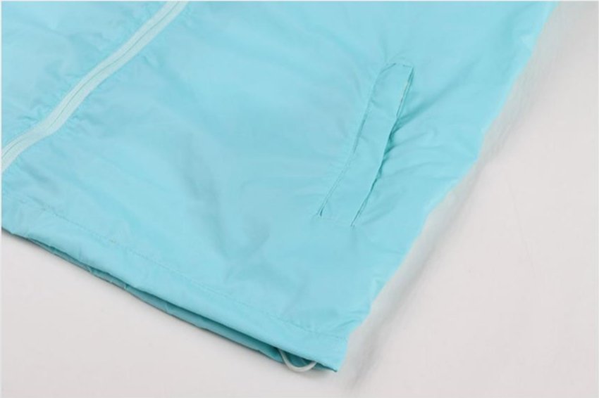 Side pocket detail of light blue soccer windbreaker