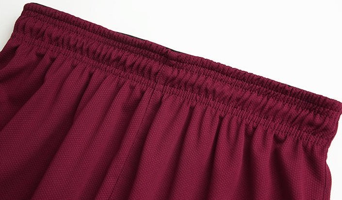ack view of maroon basketball shorts with elastic waistband