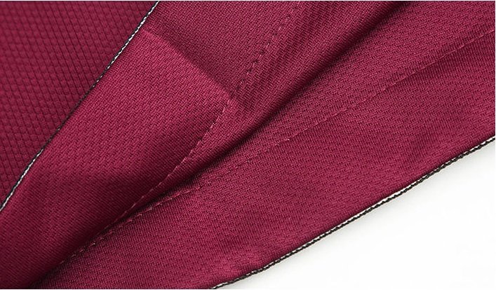 Close-up of maroon mesh fabric and stitching on basketball shorts