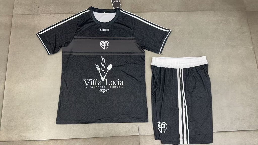 Wholesale custom black soccer jersey and shorts front view, with white elastic waistband, shoulder stripes, and heat transfer sponsor logo, perfect for small batch OEM orders.