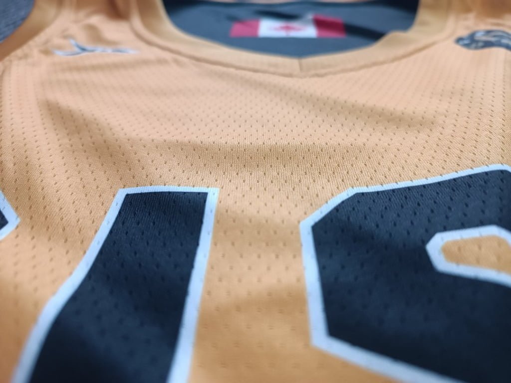 Close-up of number print and mesh texture on yellow reversible basketball jersey